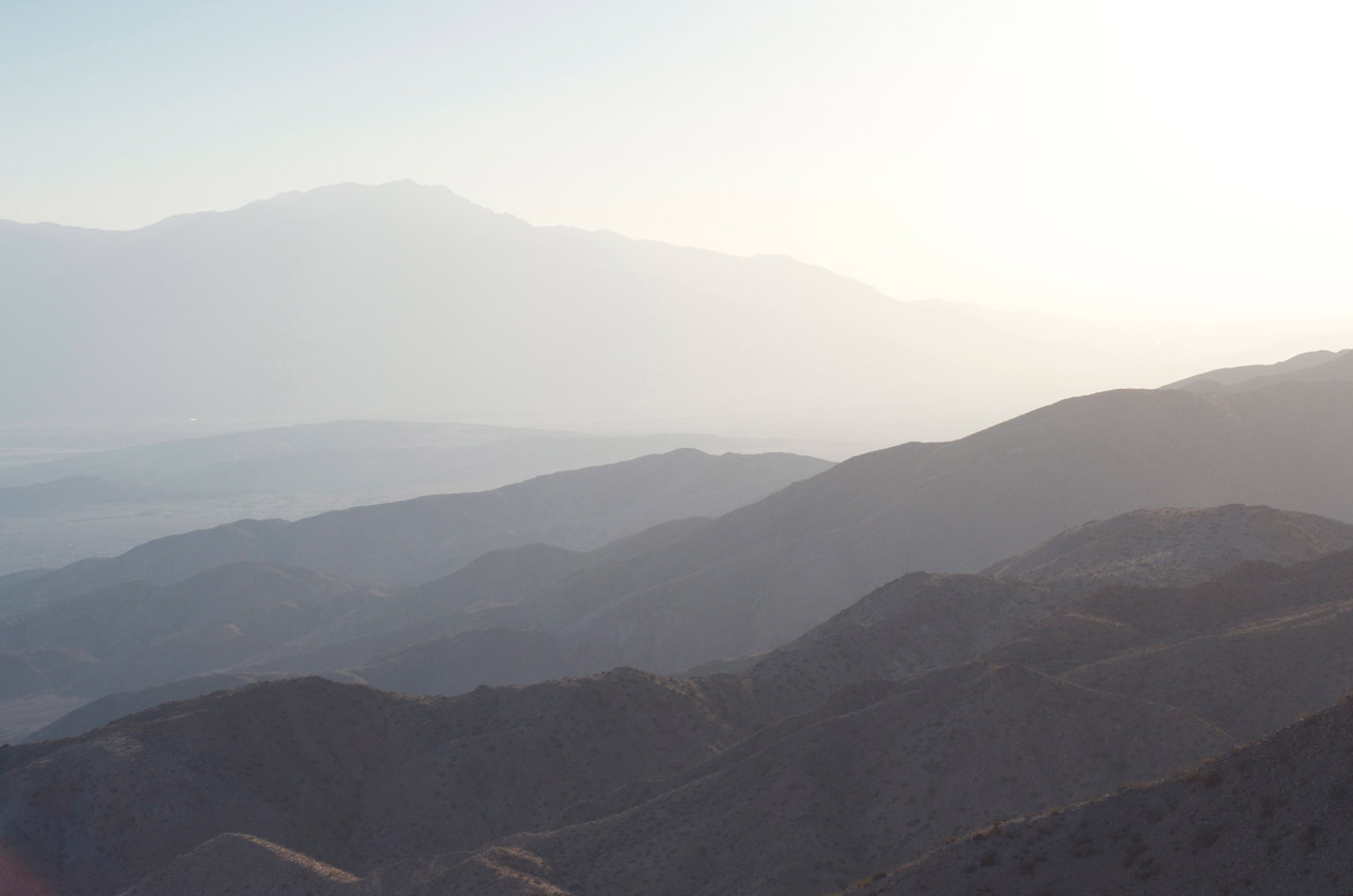The ultimate in bum travel clothes - a shredded band t shirt, denim shorts, and a deadpan demeanour